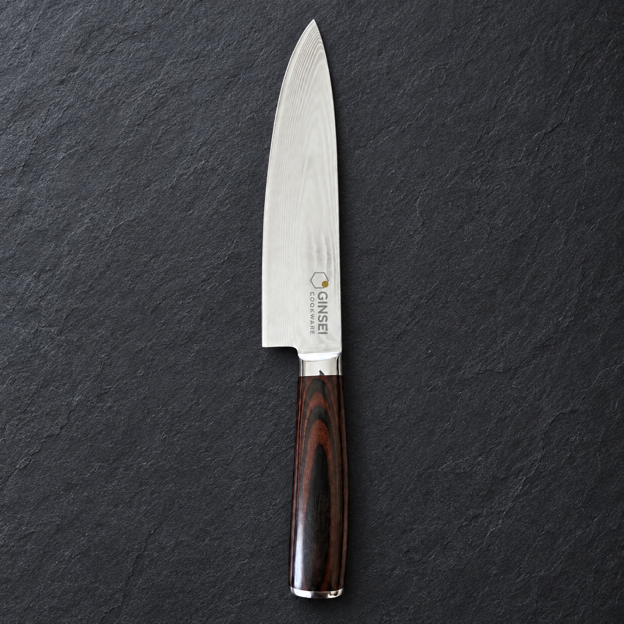 A pristine GINSEI Damascus chef’s knife with a mirror edge